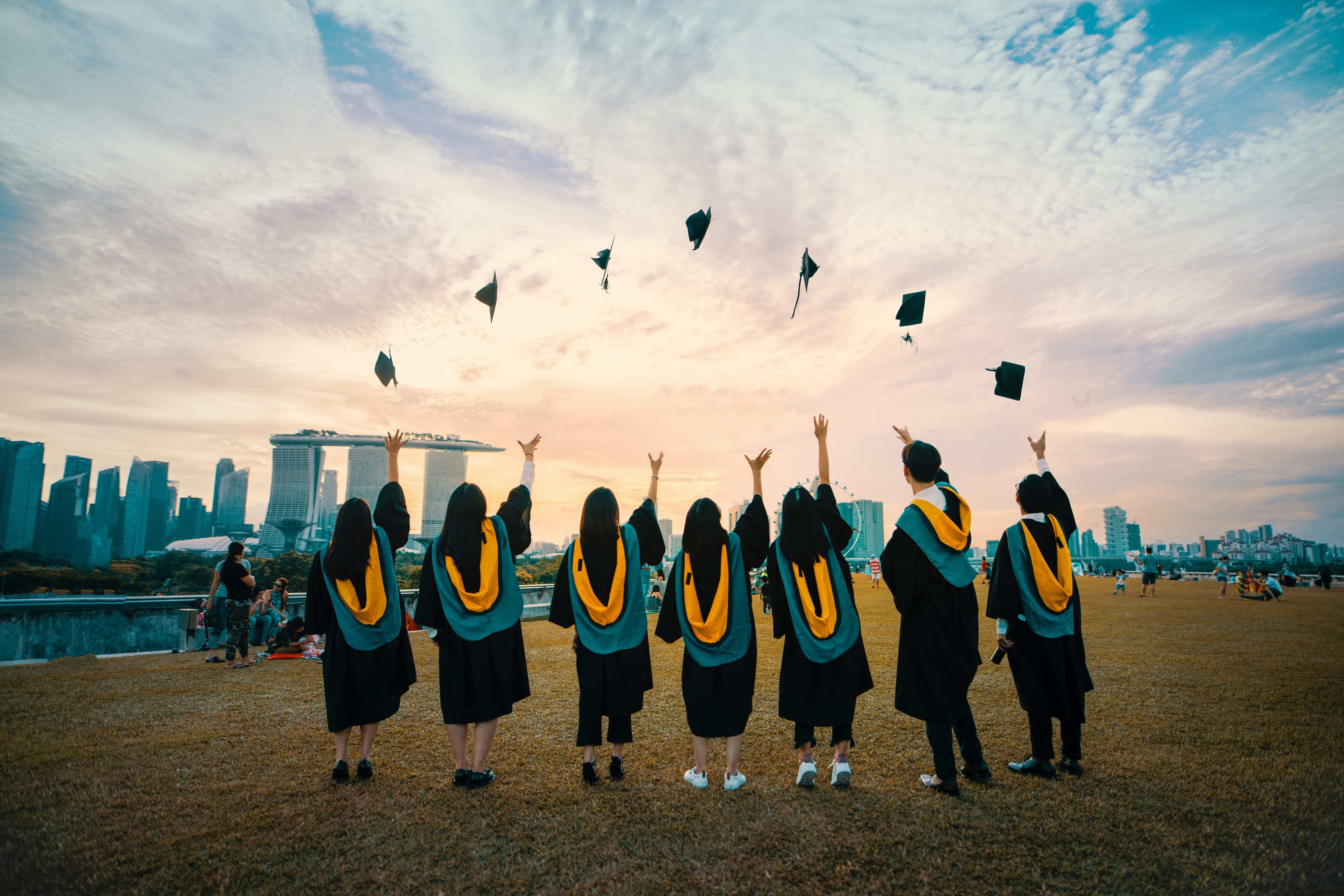 Graduates throwing their caps into the air